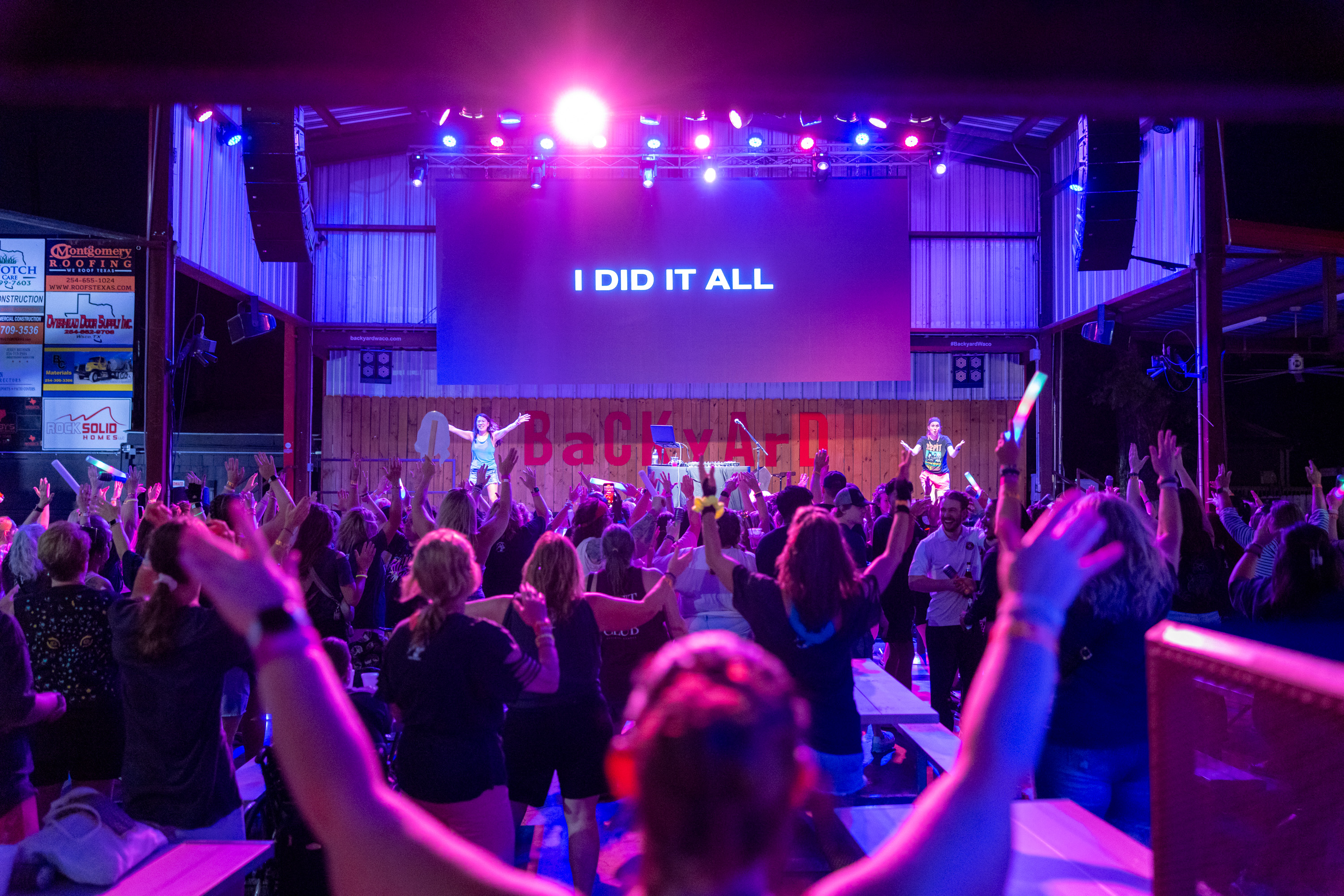 A REFIT crowd with hands up at an outdoor stage
